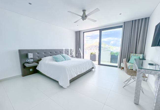 Double bedroom with TV and private Jacuzzi terrace access facing Simpson Bay