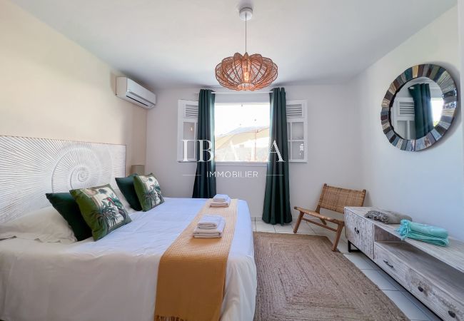 Large air-conditioned bedroom with window overlooking the swimming pool and king size bed