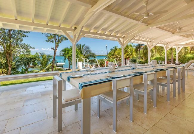 Large dining table for 10 people on the terrace with pool and sea view