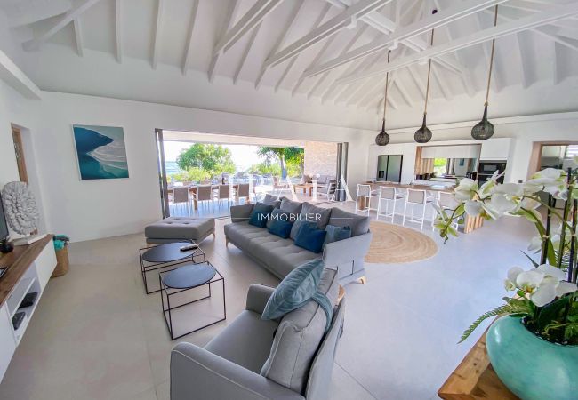 Large living room open on the kitchen and the terrace finely decorated with exposed beams