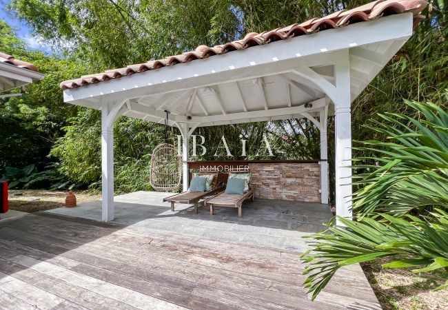Pergola and tile roof with wooden garden furniture