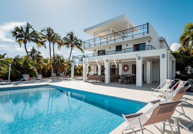 White house with pool and palm trees