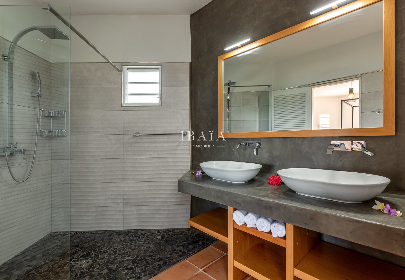 Bathroom with double washbasin and walk-in shower