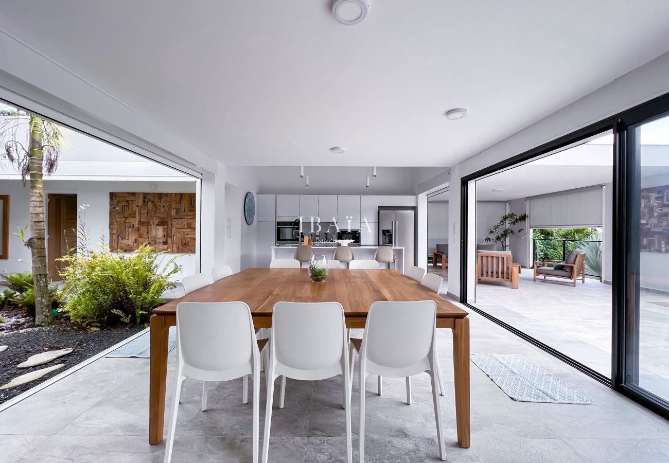 Large wooden dining table with access to the interior patio and exterior terrace