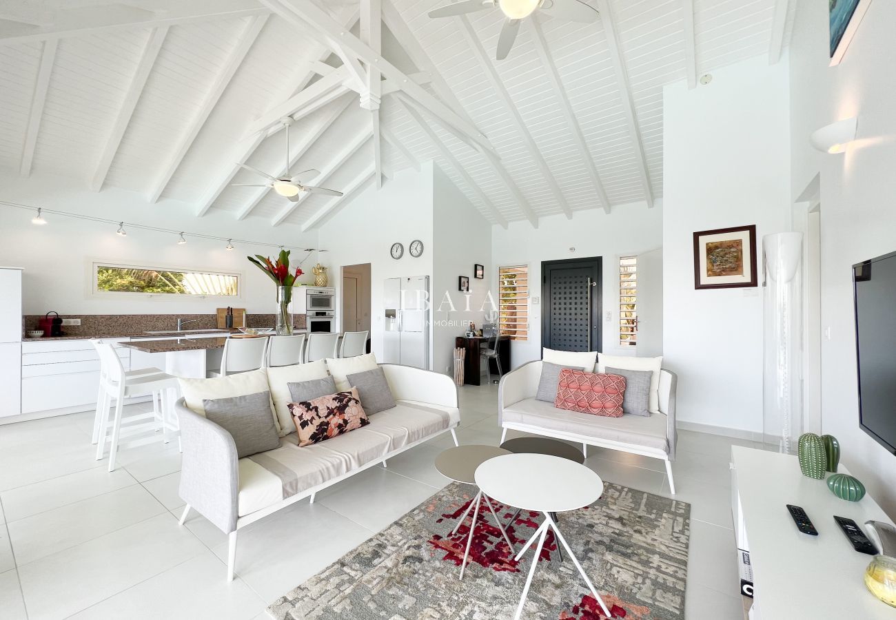 Living room with TV and kitchen area with central island
