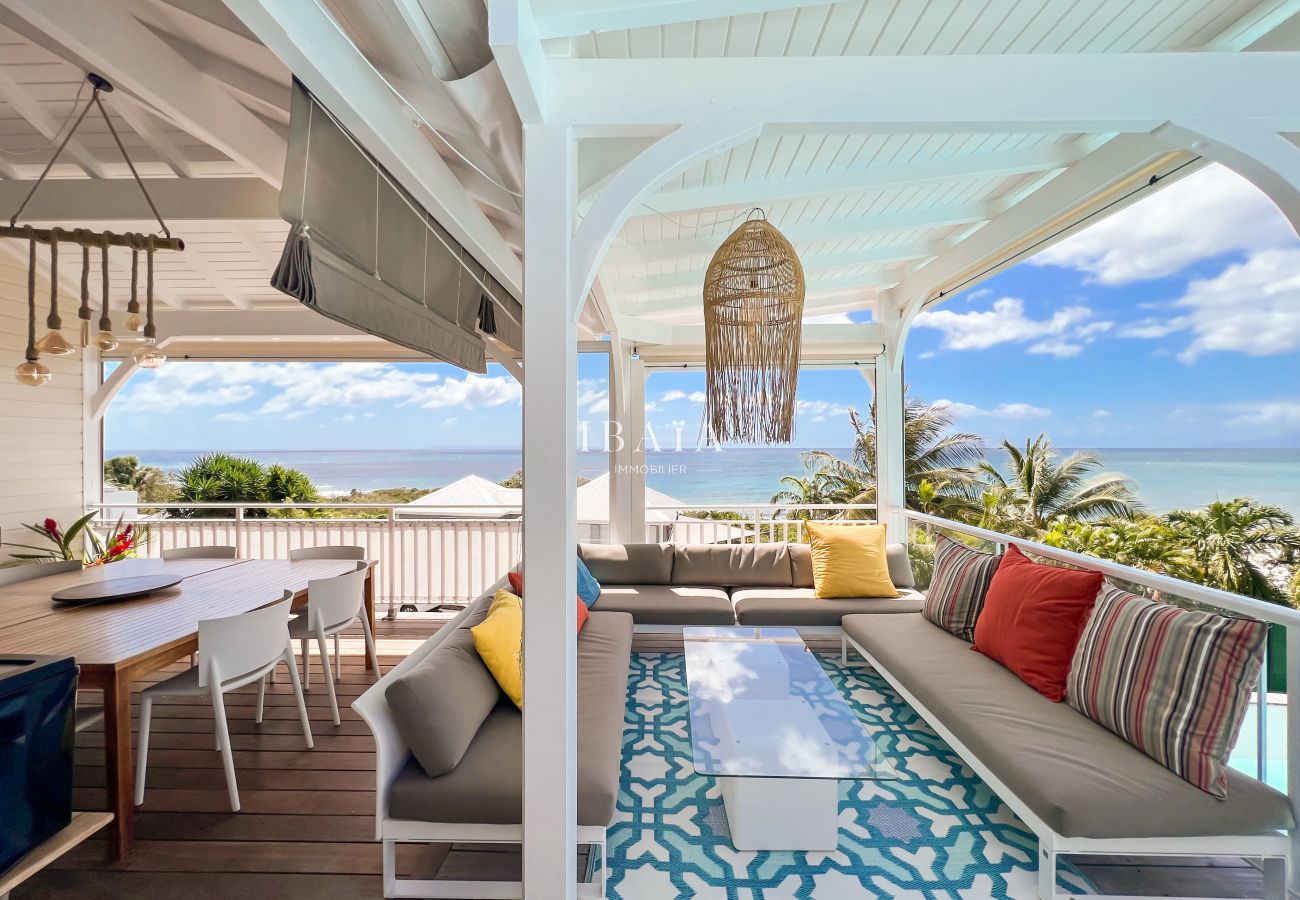 Terrace dining room wooden table garden furniture sea view swimming pool