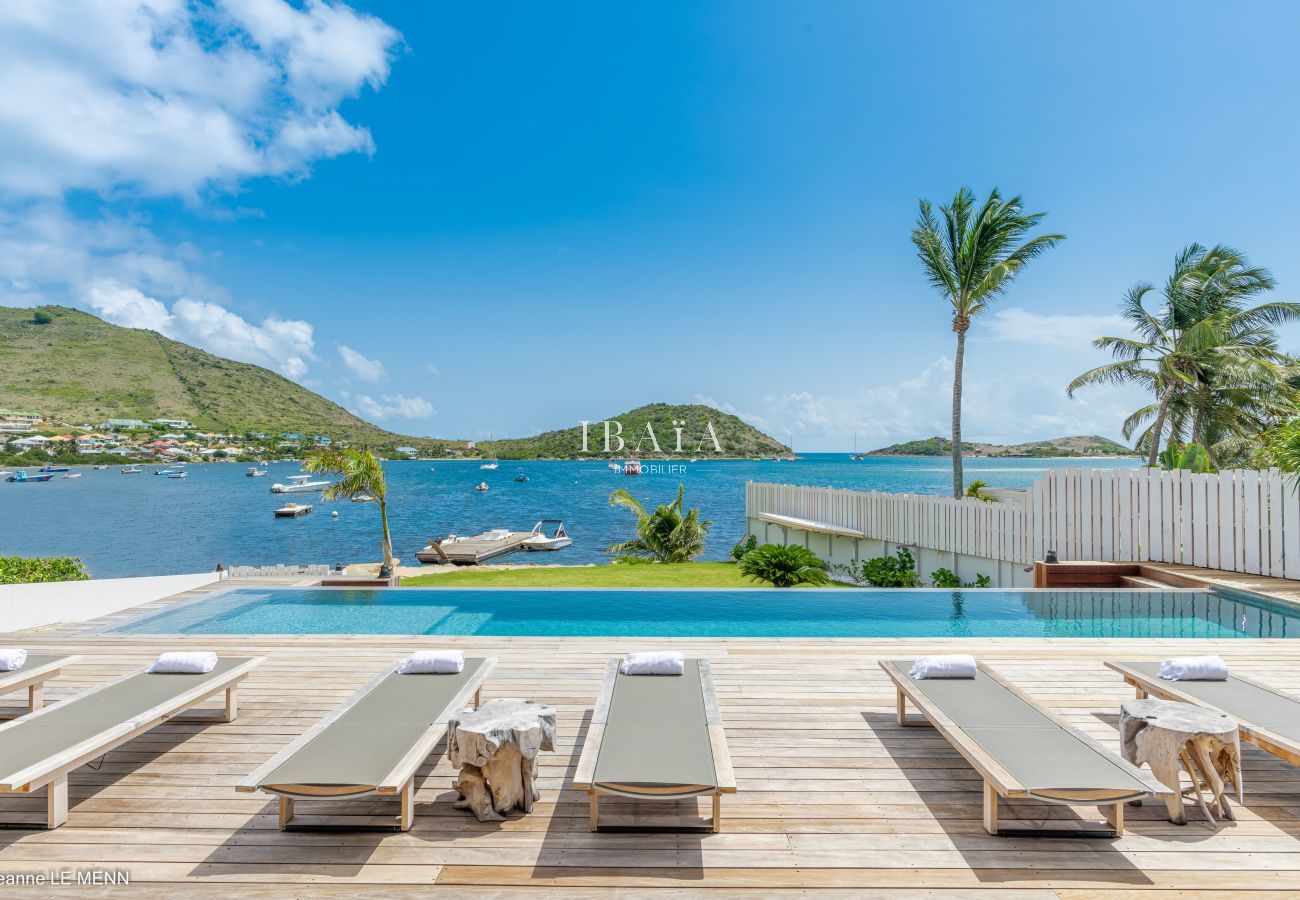 Overflowing swimming pool terrace wood deckchair sea view close to beaches