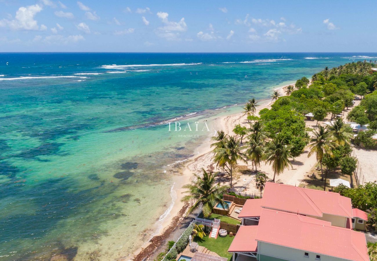 Aerial view of the seafront villa with sandy beach and superb views of the sea bed